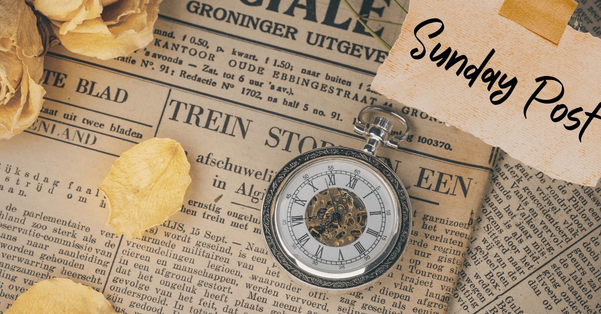 Sunday Post Page Header: Background shows old newspapers stacked haphazardly. Sitting on top are an old watch pendant, a yellowed rose with a few petals scattered about, and a piece of scrap paper held in place by masking tape which says Sunday Post.