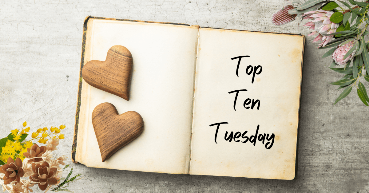 Open book with the left pages weighted down by two wooden hearts, and the write page showing the words 'Top Ten Tuesday'. The top right and bottom left corners of the page are bordered by Australian wildflowers.